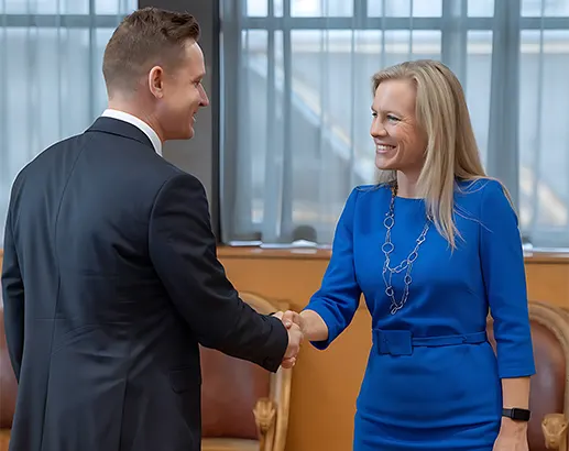 Two professionals shaking hands during a meeting, representing outsourced accounting services in North Carolina.