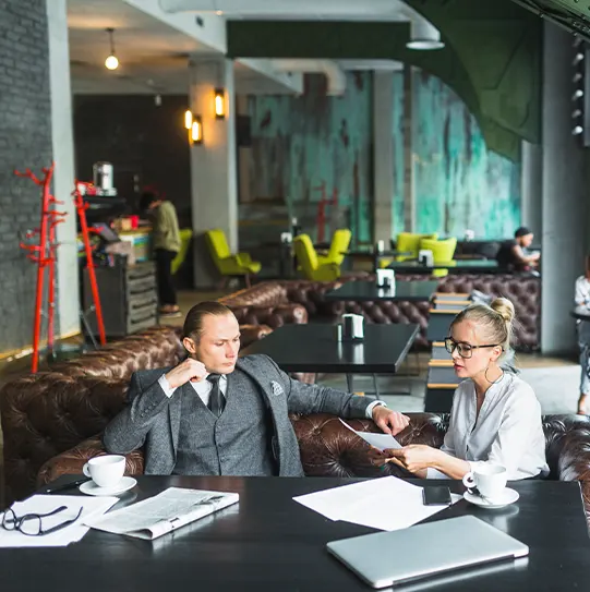 Business partners discussing a Bookkeeping Franchise investment and financial strategy during a professional consultation meeting.