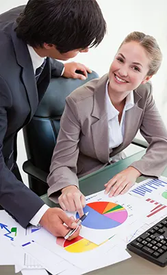 A collaborative Bookkeeping Service for Franchises showing professionals analyzing a pie chart to optimize cash flow and profit margins.