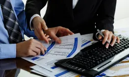 A professional advisor discussing strategy in a modern office, representing the personalized touch of Outsourced Finance and Accounting Services in Virginia.