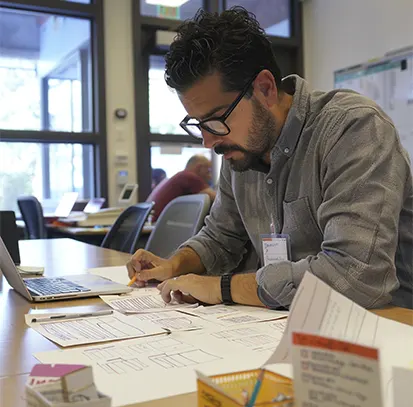 A focused professional reviewing invoice documents and financial paperwork, illustrating the dedicated support provided by receivable services for startups.