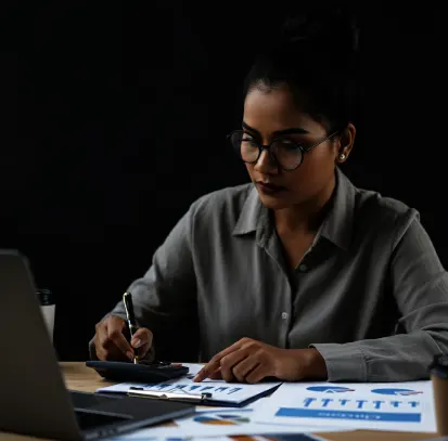 Professional woman working on tax management documents for startups, reviewing financial reports and managing taxes.