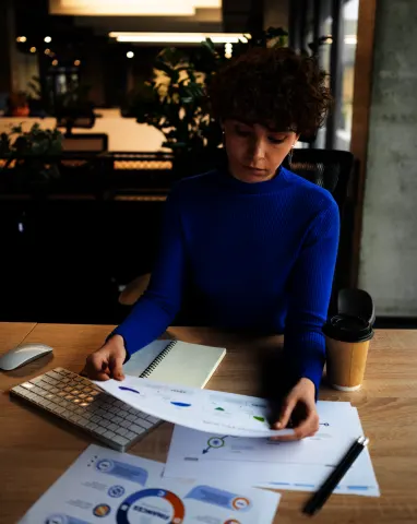 Financial consultant working with tax data and business reports, representing outsourced tax management services for startups.