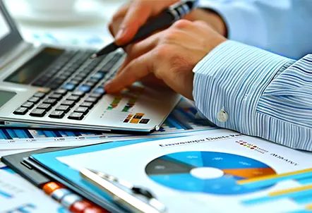 An accountant managing financial data on a laptop, providing efficient accounts payable services for small businesses.