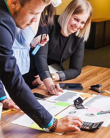 Startup professionals reviewing cash flow reports and calculations as part of reliable bookkeeping services for startups.