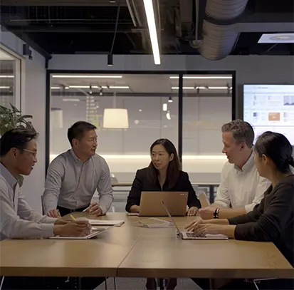 A diverse leadership team in a boardroom meeting discussing strategic financial planning and startup scaling.