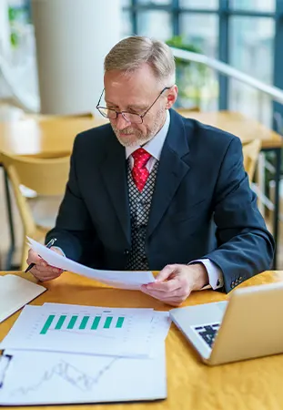 NYC virtual CPA analyzing business reports on laptop