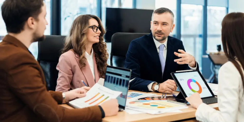 Financial advisors discussing succession planning strategies in a professional office meeting