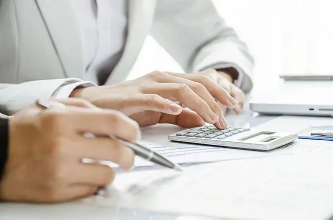 Business professional using a calculator for financial planning